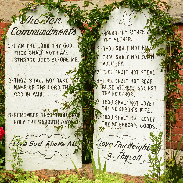 large stones covered with vines with the 10 commandments on them